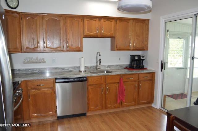 14 Ardsley Ave Unit 64, Whiting, NJ 08759 - kitchen with appliances with stainless steel finishes, a sink, brown cabinets, and light wood finished floors