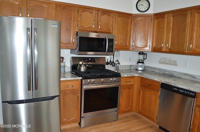 14 Ardsley Ave Unit 64, Whiting, NJ 08759 - kitchen with stainless steel appliances, brown cabinets, and light wood finished floors