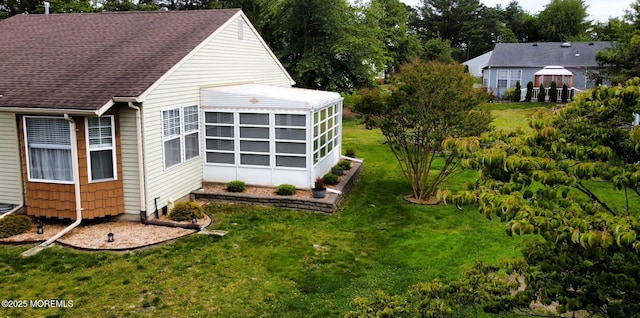 14 Ardsley Ave Unit 64, Whiting, NJ 08759 - view of property exterior with a lawn, a sunroom, and a shingled roof
