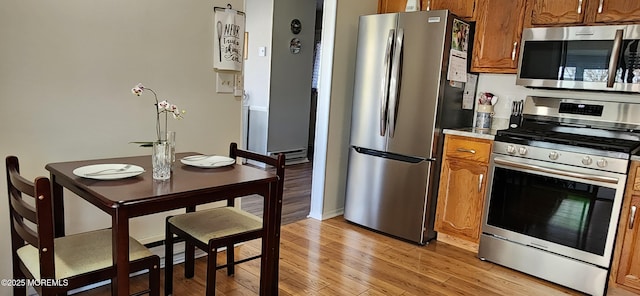 14 Ardsley Ave Unit 64, Whiting, NJ 08759 - kitchen featuring stainless steel appliances, brown cabinets, light wood finished floors, and light countertops