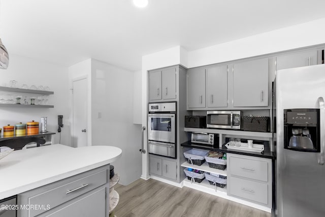 90 Old Bridge Dr, Howell, NJ 07731 - kitchen featuring stainless steel appliances, gray cabinets, a warming drawer, light wood-type flooring, and light countertops