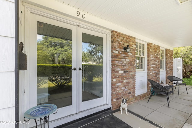 90 Old Bridge Dr, Howell, NJ 07731 - entrance to property featuring french doors, covered porch, and brick siding