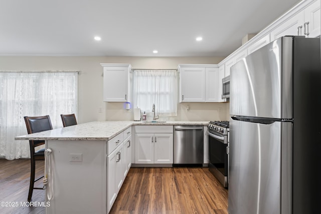 8 Carter Way, Brick, NJ 08723 - kitchen featuring stainless steel appliances, a peninsula, white cabinetry, a breakfast bar, and dark wood finished floors