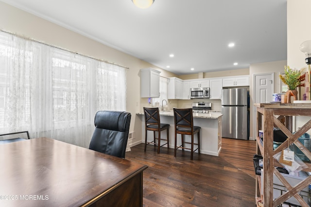 8 Carter Way, Brick, NJ 08723 - kitchen featuring appliances with stainless steel finishes, a peninsula, dark wood finished floors, light stone counters, and white cabinetry