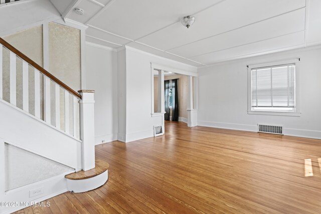 42 Chestnut St, Red Bank, NJ 07701 - unfurnished living room with wood finished floors, baseboards, stairway, and crown molding