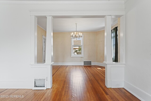42 Chestnut St, Red Bank, NJ 07701 - unfurnished dining area featuring hardwood / wood-style flooring, a chandelier, baseboards, and crown molding