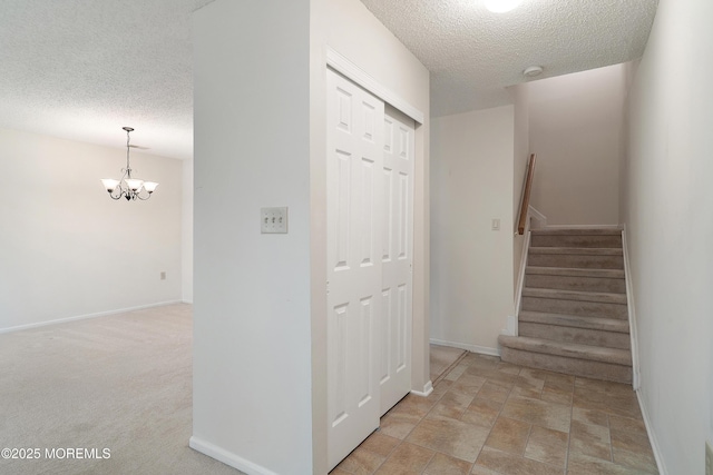 29 Copley Ct Unit 6, Freehold, NJ 07728 - stairs with a textured ceiling, a chandelier, and baseboards