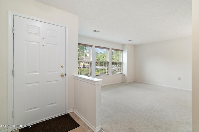 29 Copley Ct Unit 6, Freehold, NJ 07728 - carpeted entrance foyer with baseboards and a textured ceiling