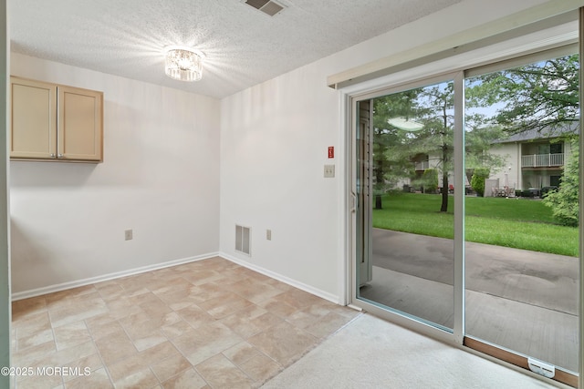 29 Copley Ct Unit 6, Freehold, NJ 07728 - empty room with a textured ceiling, baseboards, and a chandelier