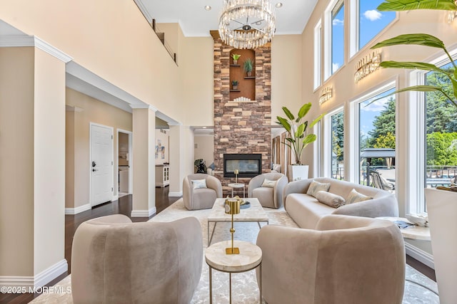 806 Turquoise Trl, Morganville, NJ 07751 - living room with plenty of natural light, a chandelier, a high ceiling, a fireplace, and crown molding