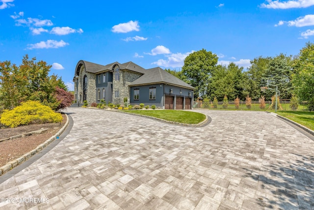 806 Turquoise Trl, Morganville, NJ 07751 - french country style house featuring decorative driveway, stone siding, and an attached garage