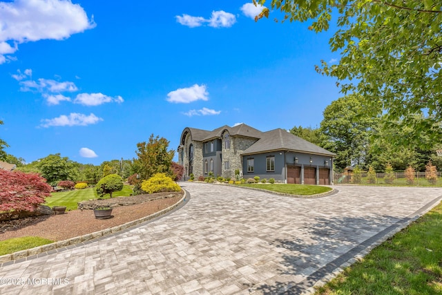 806 Turquoise Trl, Morganville, NJ 07751 - view of front facade featuring stone siding, curved driveway, and an attached garage