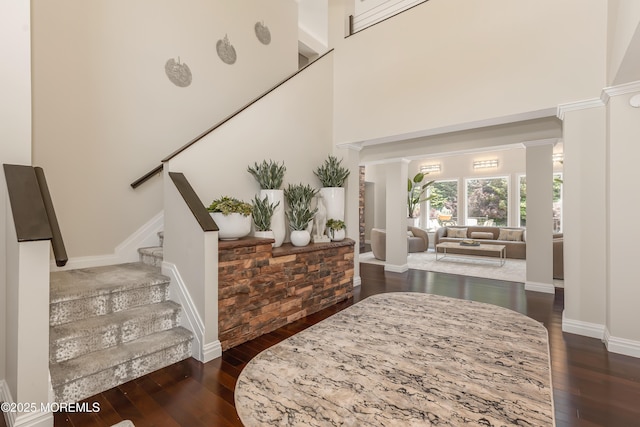 806 Turquoise Trl, Morganville, NJ 07751 - foyer featuring dark wood-type flooring, stairway, ornate columns, and a high ceiling