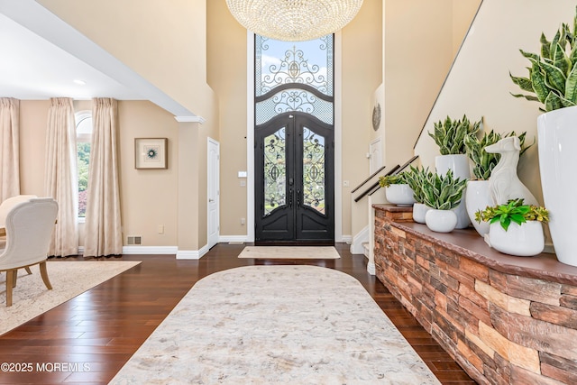 806 Turquoise Trl, Morganville, NJ 07751 - foyer featuring a towering ceiling, a chandelier, dark wood-style flooring, and french doors