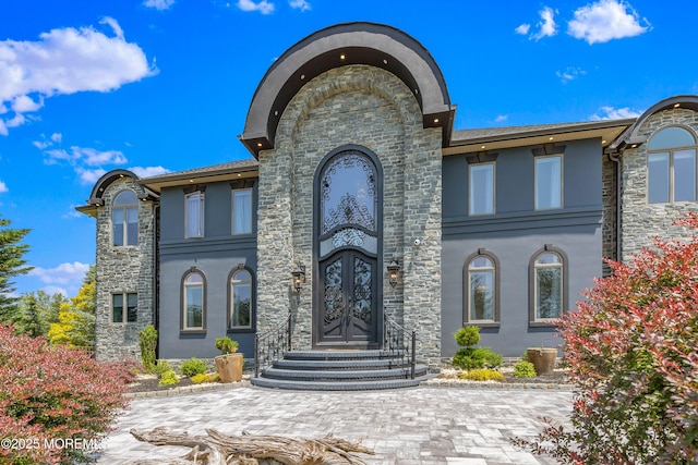 806 Turquoise Trl, Morganville, NJ 07751 - view of front of home with stucco siding, stone siding, and french doors