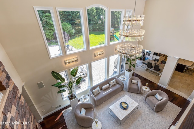806 Turquoise Trl, Morganville, NJ 07751 - living area with plenty of natural light, a high ceiling, a chandelier, and wood finished floors