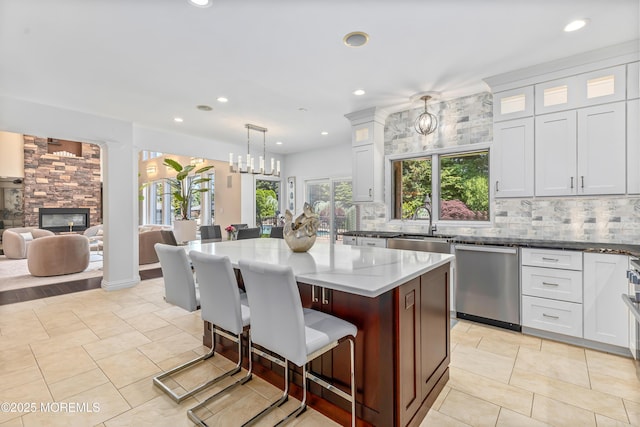 806 Turquoise Trl, Morganville, NJ 07751 - kitchen featuring stainless steel dishwasher, dark stone counters, a kitchen bar, recessed lighting, and backsplash