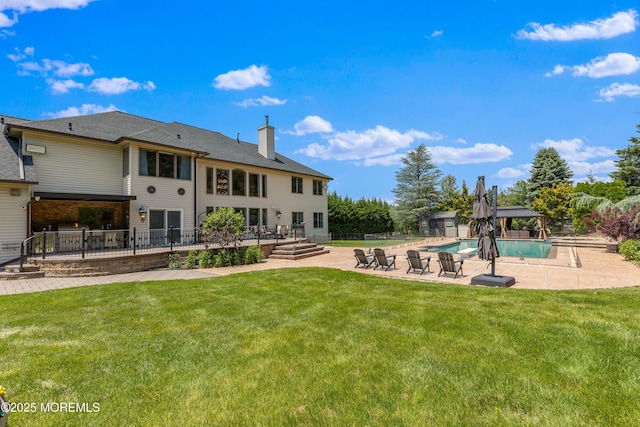 806 Turquoise Trl, Morganville, NJ 07751 - back of house featuring a patio area, an outdoor pool, a chimney, a yard, and a deck