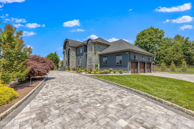 806 Turquoise Trl, Morganville, NJ 07751 - view of front of house featuring stone siding, decorative driveway, a garage, and stucco siding