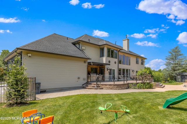 806 Turquoise Trl, Morganville, NJ 07751 - back of property with a patio area, a lawn, a chimney, and roof with shingles