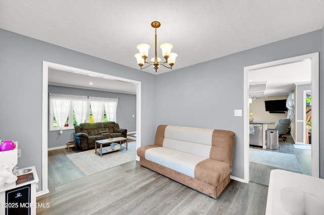 512 Highland Ter, Brick, NJ 08723 - living room featuring wood finished floors, a chandelier, and baseboards