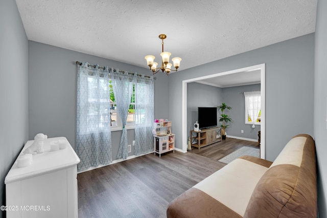 512 Highland Ter, Brick, NJ 08723 - living area featuring wood finished floors, a chandelier, plenty of natural light, a textured ceiling, and baseboards