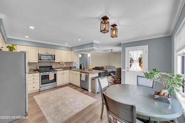 512 Highland Ter, Brick, NJ 08723 - kitchen featuring stainless steel appliances, cream cabinetry, a sink, plenty of natural light, and ornamental molding
