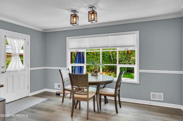 512 Highland Ter, Brick, NJ 08723 - dining area with baseboards, wood finished floors, and ornamental molding