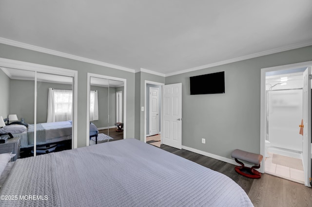512 Highland Ter, Brick, NJ 08723 - bedroom with multiple closets, dark wood-style flooring, baseboards, crown molding, and connected bathroom