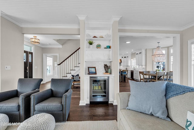333 Barkentine Ln, Mantoloking, NJ 08738 - living area featuring wine cooler, a chandelier, dark wood-style floors, ornamental molding, and stairs