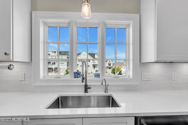 333 Barkentine Ln, Mantoloking, NJ 08738 - kitchen with a sink, dishwashing machine, tasteful backsplash, light stone countertops, and white cabinetry