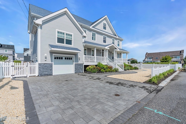 333 Barkentine Ln, Mantoloking, NJ 08738 - view of front of property with covered porch, a gate, decorative driveway, stone siding, and a garage