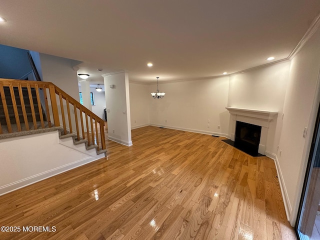 1508 Alpine Trl Unit 1508, Neptune Township, NJ 07753 - unfurnished living room featuring stairway, ornamental molding, a fireplace with flush hearth, a chandelier, and light wood finished floors