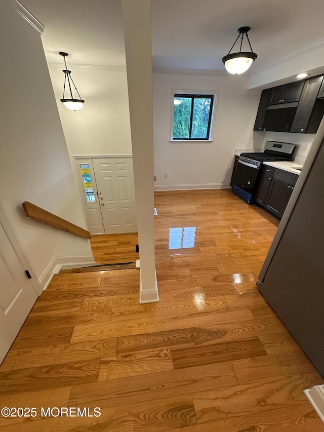 1508 Alpine Trl Unit 1508, Neptune Township, NJ 07753 - kitchen with range with gas stovetop, baseboards, light wood finished floors, dark cabinets, and hanging light fixtures