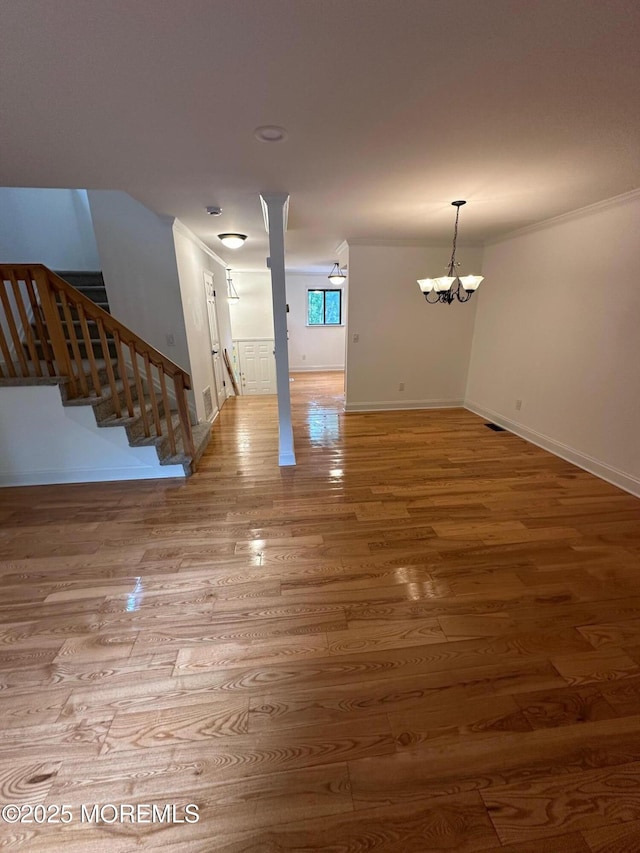 1508 Alpine Trl Unit 1508, Neptune Township, NJ 07753 - unfurnished living room featuring wood finished floors, a chandelier, stairway, baseboards, and crown molding
