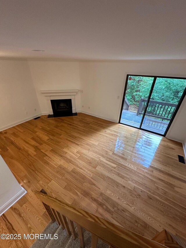 1508 Alpine Trl Unit 1508, Neptune Township, NJ 07753 - unfurnished living room featuring light wood-type flooring, a fireplace with flush hearth, and baseboards