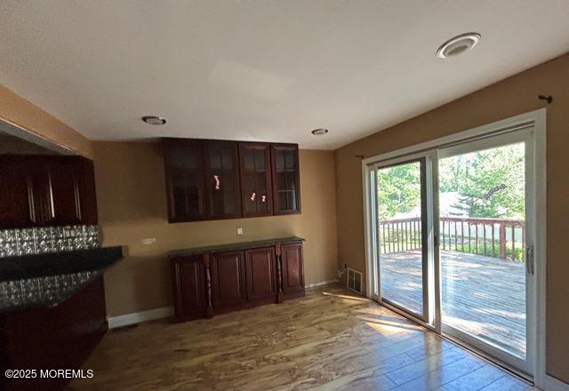 90 Statesir Pl, Red Bank, NJ 07701 - kitchen with baseboards, wood finished floors, glass insert cabinets, and dark brown cabinets