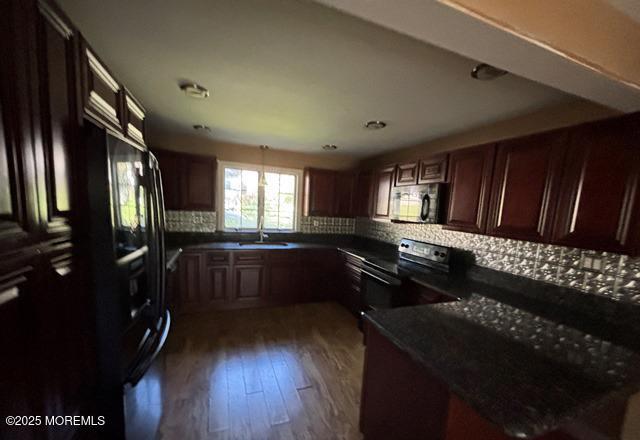 90 Statesir Pl, Red Bank, NJ 07701 - kitchen with black range with electric stovetop, dark countertops, tasteful backsplash, and dark wood-type flooring