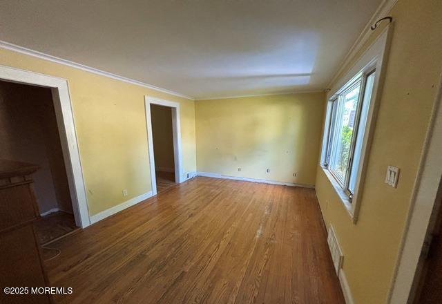 90 Statesir Pl, Red Bank, NJ 07701 - unfurnished bedroom with wood finished floors, ornamental molding, and baseboards