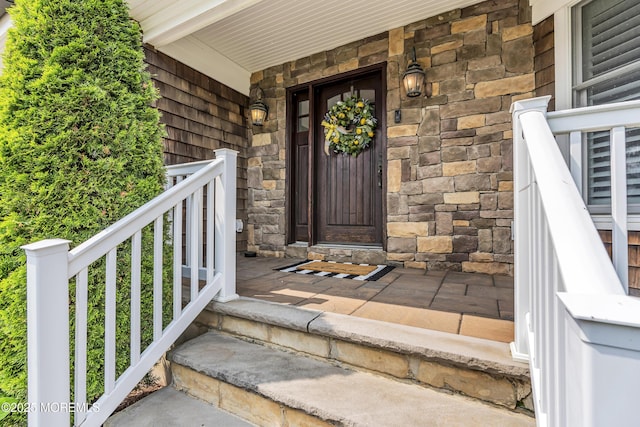 2117 Seagull Ter, Point Pleasant, NJ 08742 - view of exterior entry featuring stone siding and a porch