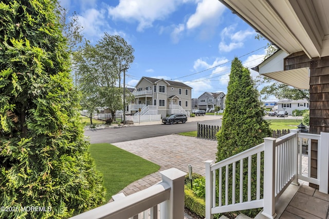 2117 Seagull Ter, Point Pleasant, NJ 08742 - view of yard featuring a residential view, a porch, and decorative driveway