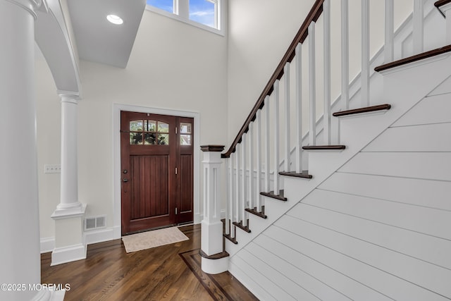 2117 Seagull Ter, Point Pleasant, NJ 08742 - entrance foyer with a high ceiling, decorative columns, healthy amount of natural light, dark wood-style flooring, and stairway