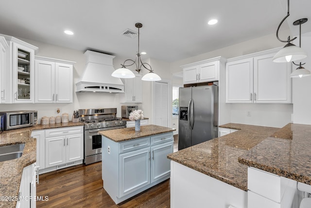 2117 Seagull Ter, Point Pleasant, NJ 08742 - kitchen featuring stainless steel appliances, premium range hood, white cabinets, a center island, and dark wood-style flooring