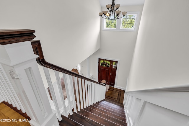 2117 Seagull Ter, Point Pleasant, NJ 08742 - staircase with a chandelier, wood finished floors, and a towering ceiling