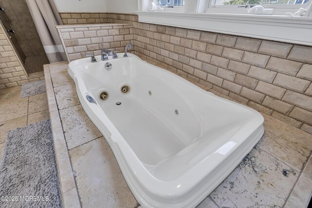 2117 Seagull Ter, Point Pleasant, NJ 08742 - bathroom with a jetted tub, a stall shower, stone tile floors, and tile walls