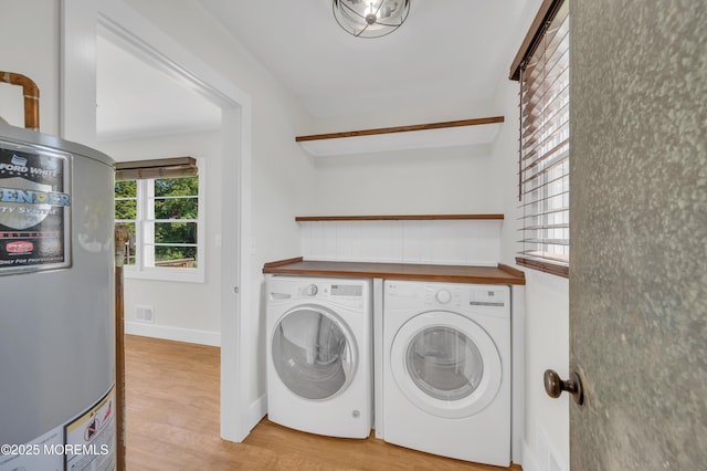 3132 Cohocton Ave, Point Pleasant, NJ 08742 - laundry room featuring washer and dryer, water heater, and light wood-type flooring