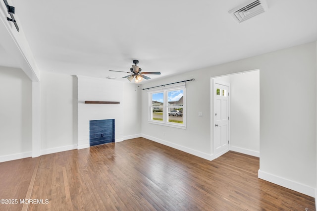 3132 Cohocton Ave, Point Pleasant, NJ 08742 - unfurnished living room with a fireplace, a ceiling fan, wood finished floors, and baseboards