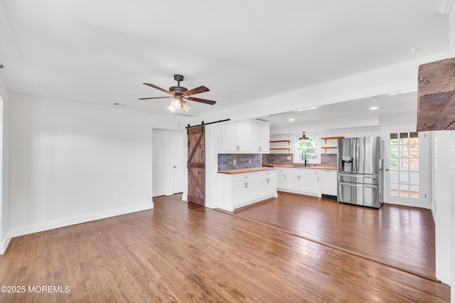 3132 Cohocton Ave, Point Pleasant, NJ 08742 - unfurnished living room with a barn door, ceiling fan, a sink, and wood finished floors