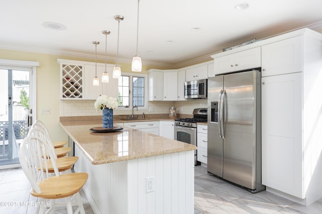 3 Watson Pl, Manasquan, NJ 08736 - kitchen featuring stainless steel appliances, plenty of natural light, backsplash, and ornamental molding