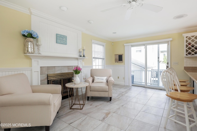 3 Watson Pl, Manasquan, NJ 08736 - living area with a fireplace, ornamental molding, a wainscoted wall, and ceiling fan